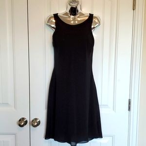 Little black dress. Knee length, sheer with built in liner/slip.
